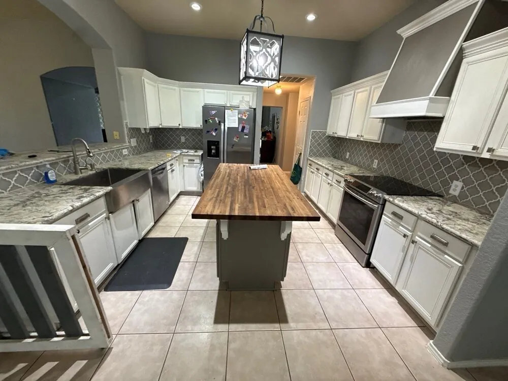 Kitchen before the remodel — white cabinets and tile floor